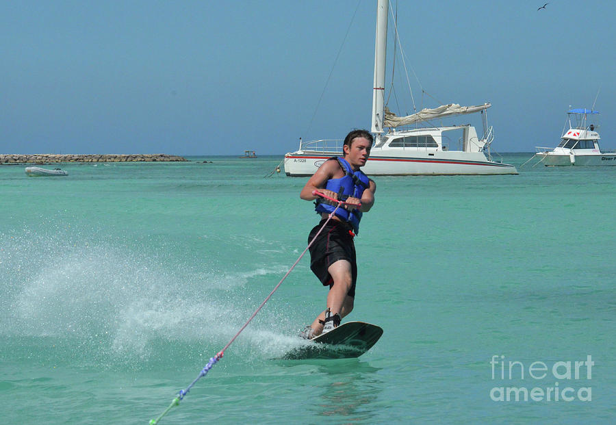 Young Guy Riding a Wakeboard Around Anchored Boats Photograph by DejaVu Designs