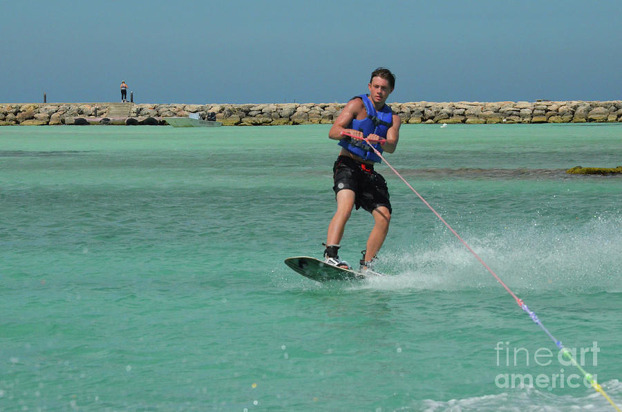 Young Guy Riding Goofy On a Wakeboard in Aruba Photograph by DejaVu Designs