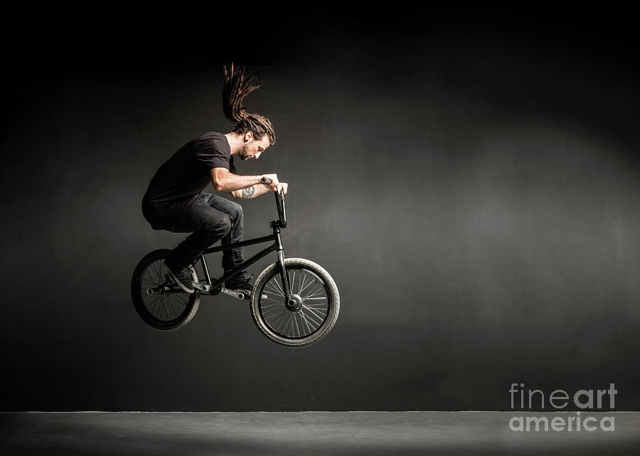 Young man doing a stunt on his BMX bicycle. Photograph by Michal Bednarek