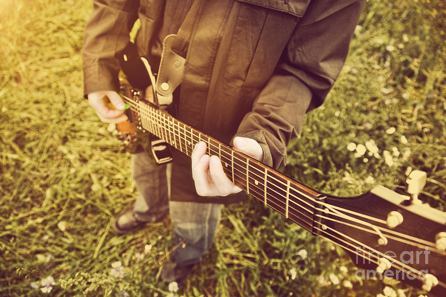 Young Man Playing On The Guitar Outdoors Photograph