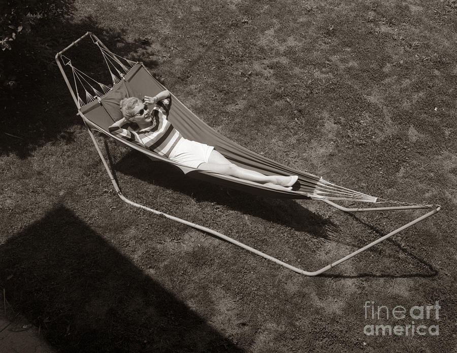 Young Woman Relaxing In Hammock Photograph by Debrocke and ClassicStock