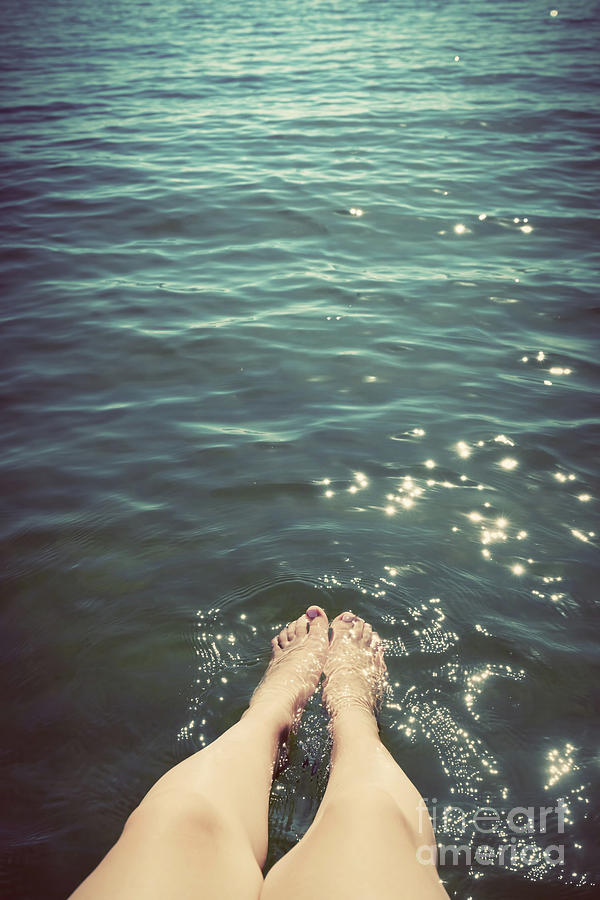 Young woman wetting her legs in the sea. Summer holidays. Vintage. Photograph by Michal Bednarek