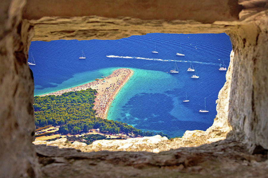 Zlatni rat beach aerial view through stone window Photograph by Brch Photography