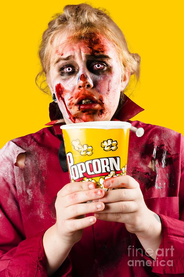 Zombie woman watching scary movie with popcorn Photograph by Jorgo Photography