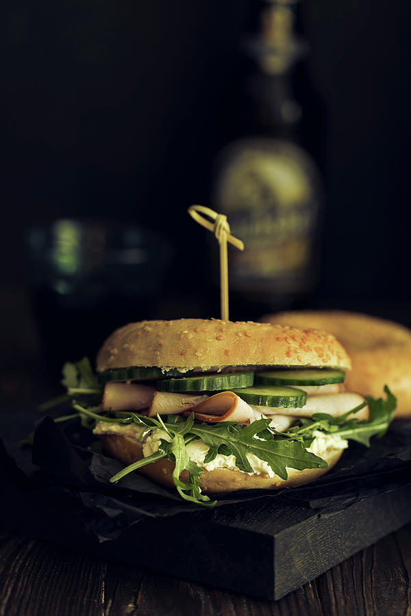 A Bagel Sandwich With Smoked Turkey Breast, Rocket And Cucumbers #1 Photograph by Valeria Aksakova