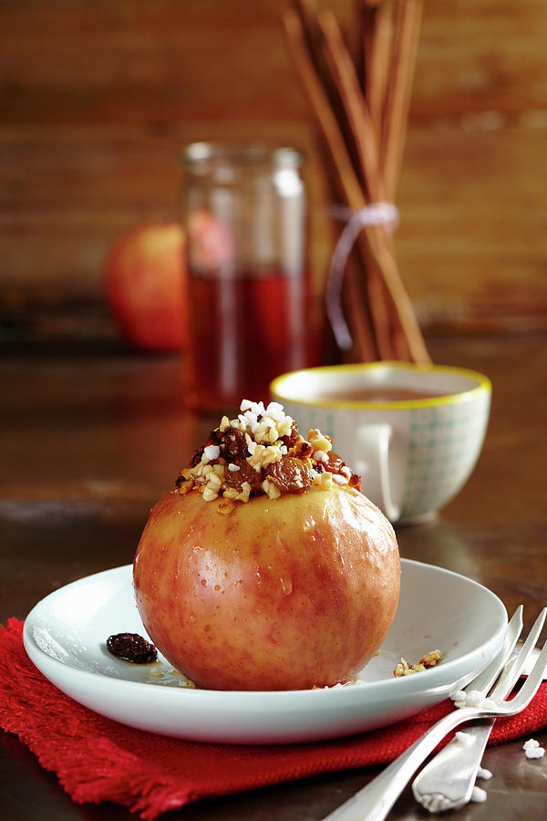 A Baked Apple With Almonds, Sultanas And Syrup christmas #1 Photograph by Teubner Foodfoto