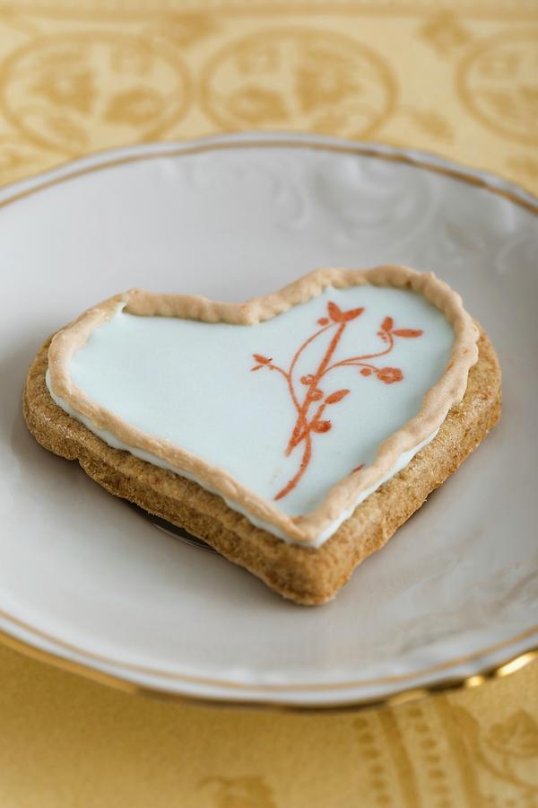 A Heart-shaped Biscuit With An Egg White Glaze And A Stamped Motif #1 Photograph by Mandy Reschke