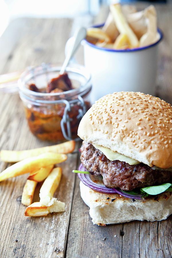 A Homemade Cheeseburger With Watercress And Chips #1 Photograph by George Blomfield