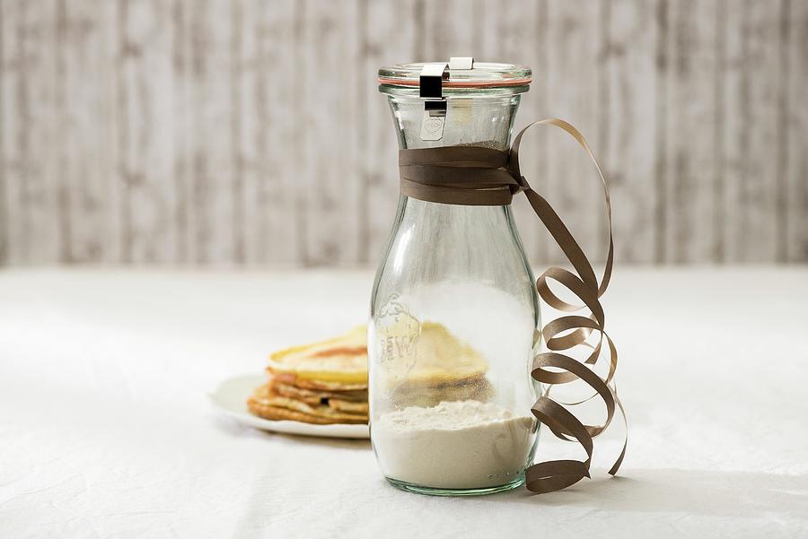 A Jar Containing The Dry Ingredient Mix For Making Pancakes And A Plate Of Cooked Pancakes #1 Photograph by Sauer, Brigitte