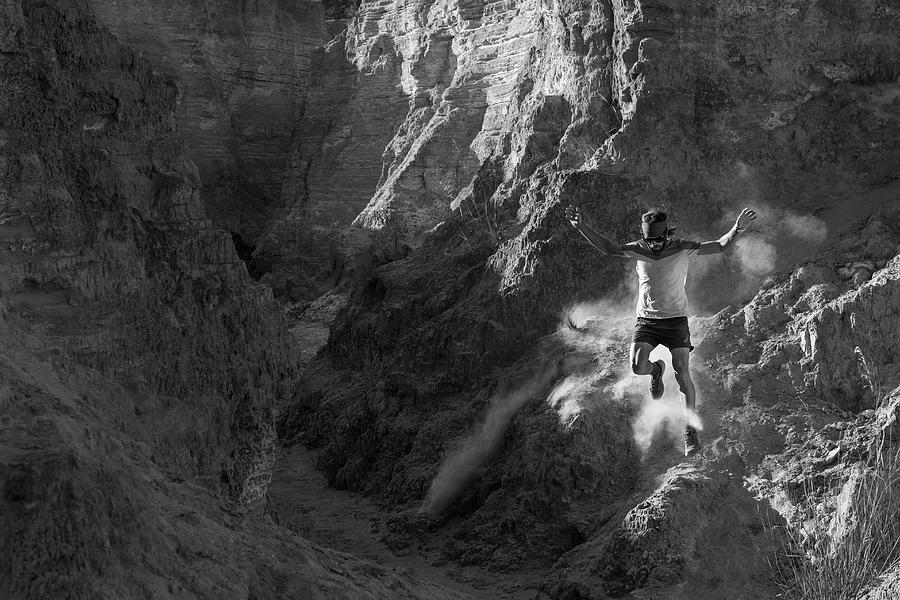 A Man Trail Running Down On Technical Terrain Leaving Dust On His Way ...