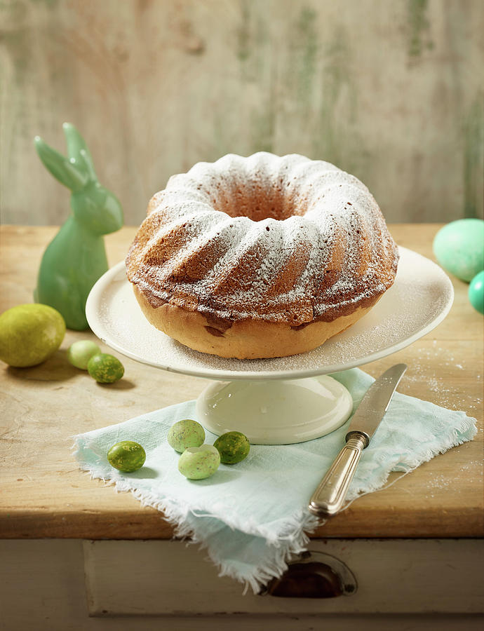 A Marble Bundt Cake Dusted With Icing Sugar With Easter Decorations #1 Photograph by Michael Lffler