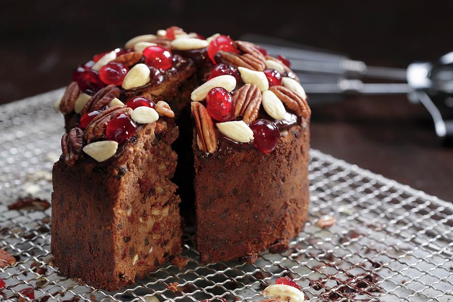 A Mini Christmas Cake With Nuts And Glace Cherries, Sliced #1 Photograph by Frank Weymann