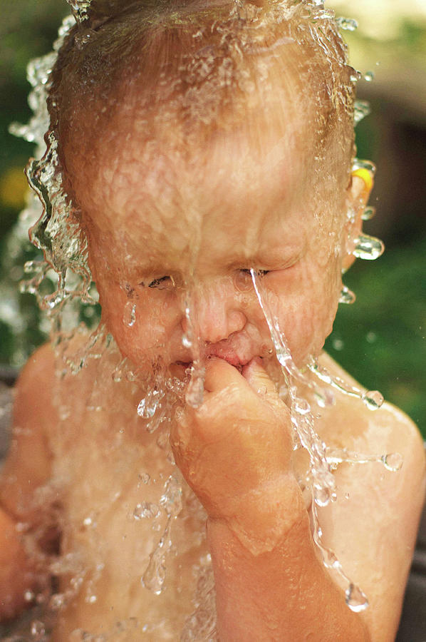 Summer Photograph - A Mother Rinses Her Sons Hair While Bathing Her In The Backyard #1 by Cavan Images