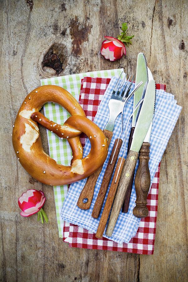 A Pretzel, Radishes And Rustic Cutlery seen From Above #1 Photograph by Sporrer/skowronek