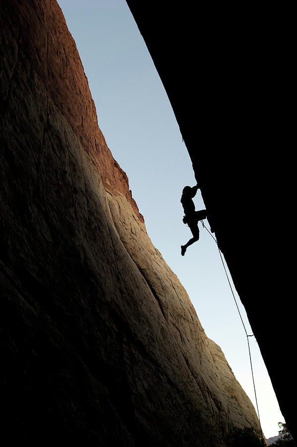 A Rock Climber Is Silhouetted As He #1 Photograph by Jared Mcmillen