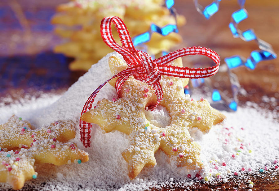 A Shortbread Snowflake Biscuit With Sugar Sprinkles And Icing Sugar #1 Photograph by Teubner Foodfoto