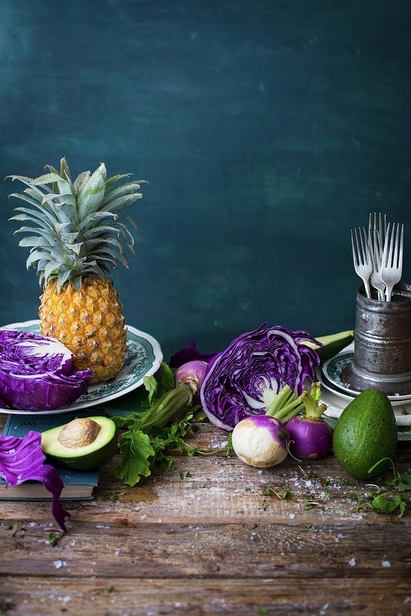 A Still Life With Red Cabbage, Pineapple, Avocado And Turnips On A Wooden Table #1 Photograph by Great Stock!