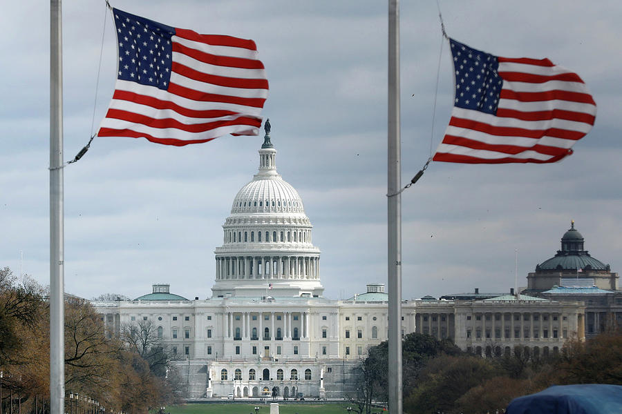 American Flags Fly with U.S. Capitol Photograph by Yuri Gripas | Pixels