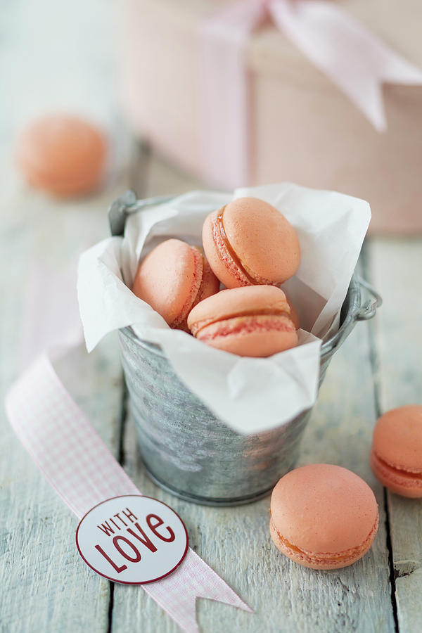 Apricot Macaroons For Valentines Day In A Paper Bag And In Front Of It #1 Photograph by Jan Wischnewski