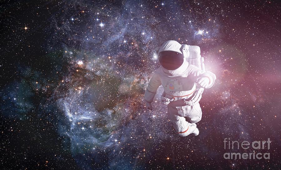 Interstellar Photograph - Astronaut exploring outer space conducting spacewalk. #1 by Michal Bednarek