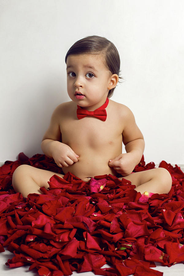 Baby Boy Sitting On White Floor With Petals Photograph