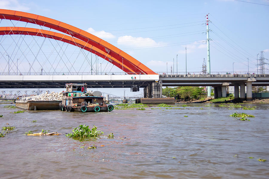 Barge Under Bridge Along Saigon River In Vietnam Photograph