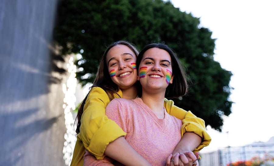 Beautiful Lesbian Couple Having Fun In The Street With A Lgtb Flag Photograph By Cavan Images 