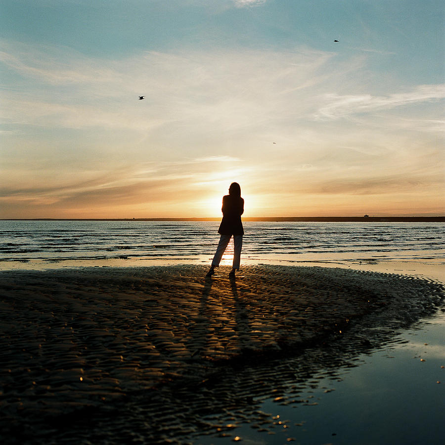 Beautiful Woman Standing Near The Sea And Enjoying The Sunset ...