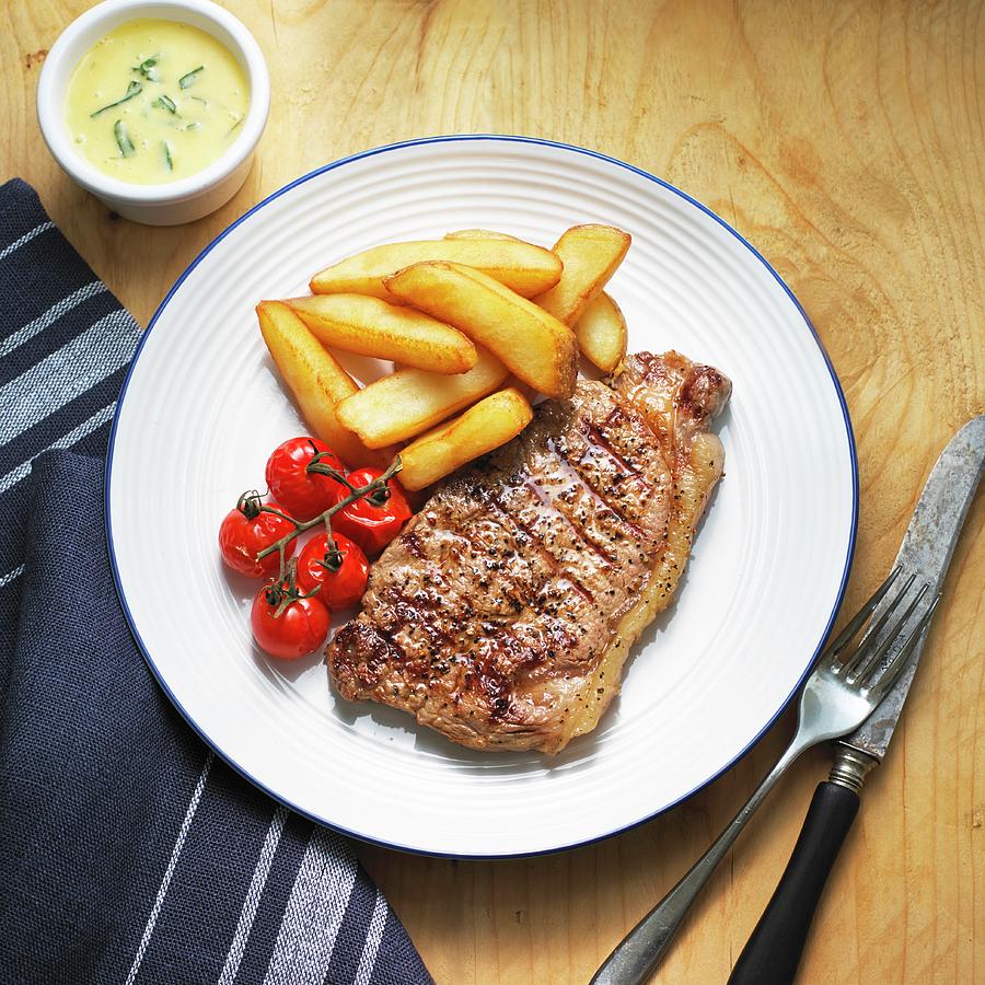 Beef Steak With Bearnaise Sauce, Chips And Cherry Tomatoes #1 Photograph by William Reavell