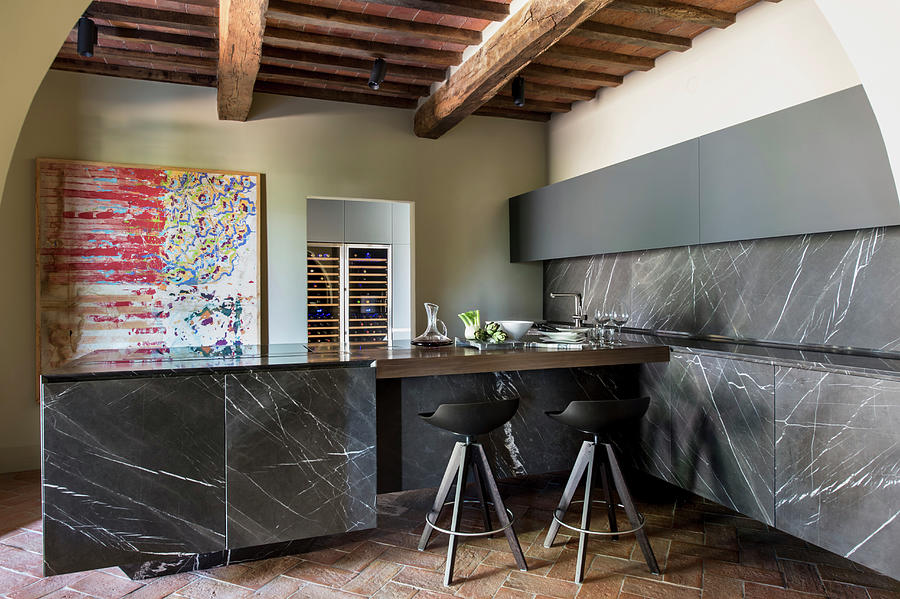 Black Marble Panels And Rustic Beams In Modern Kitchen #1 Photograph by Francesca Pagliai