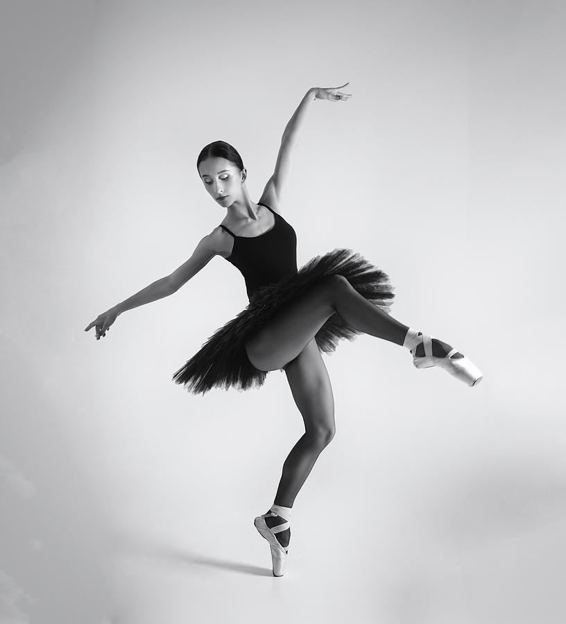 Black Swan. A Ballerina In A Black Tutu Shows Elements Of Ballet #1 Photograph by Alexandr