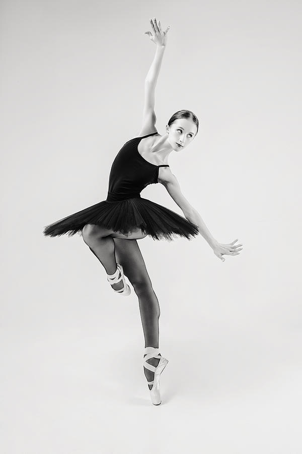 Black Swan. Ballerina In A Black Tutu Shows Elements Of Ballet Dance In Motion #1 Photograph by Alexandr