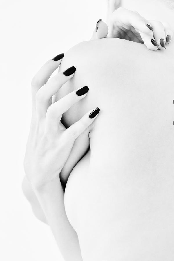 Body Parts Of A Naked Girl Torso And Hand Pressing Her Breasts With A Black Manicure On Her Nails #1 Photograph by Alexandr