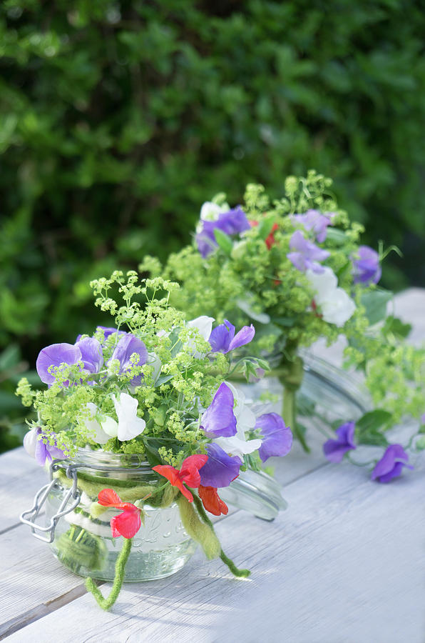 Bouquets Of Sweet Peas And Ladys Mantle In Mason Jars #1 Photograph by Martina Schindler
