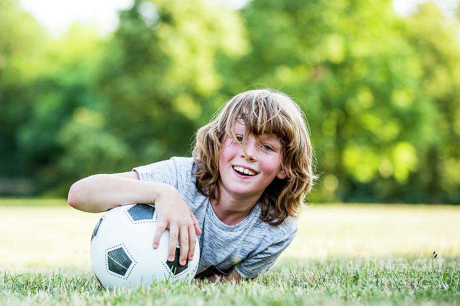 Boy Playing With Football Photograph By Science Photo Library - Pixels