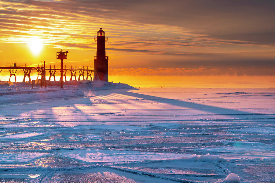 Breathtaking sunrise casts long shadows across cold, icy Algoma Harbor ...