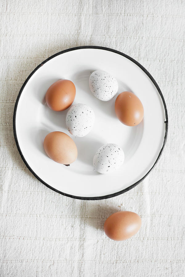 Brown Eggs And White, Speckled Eggs On Enamel Plate #1 Photograph by Alicja Koll