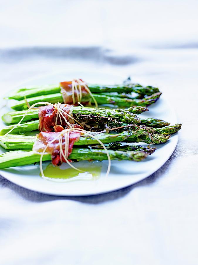 Bundles Of Green Asparagus With Anchovies, Smoked Bacon And Thyme #1 Photograph by Amiel