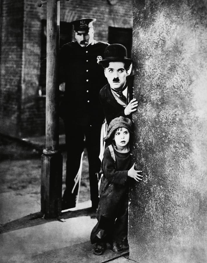 CHARLIE CHAPLIN and JACKIE COOGAN in THE KID -1921-. #1 Photograph by Album