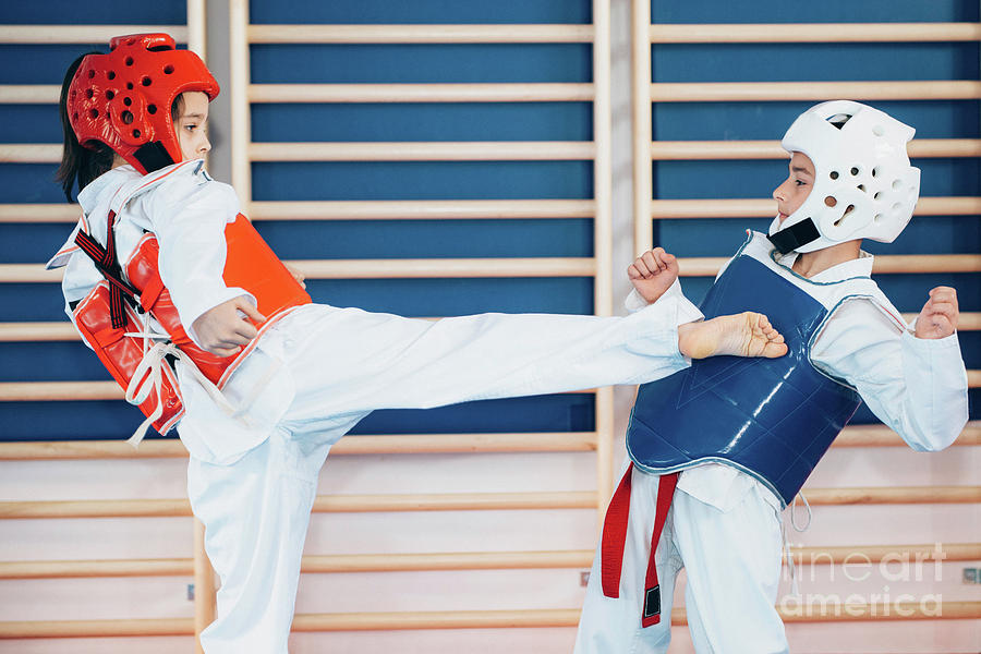 Children Sparring In Taekwondo Class Photograph by Microgen Images