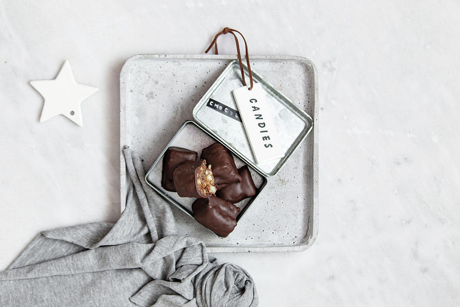Chocolate Candy With Nuts And Dates In Gift Box On White Marble Background #1 Photograph by Kapreze Kristina