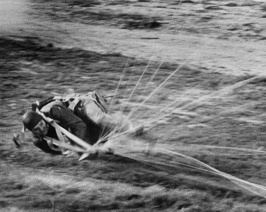 Transportation Photograph - Clark Glabe Landing On Landscape With Parachute #1 by Globe Photos