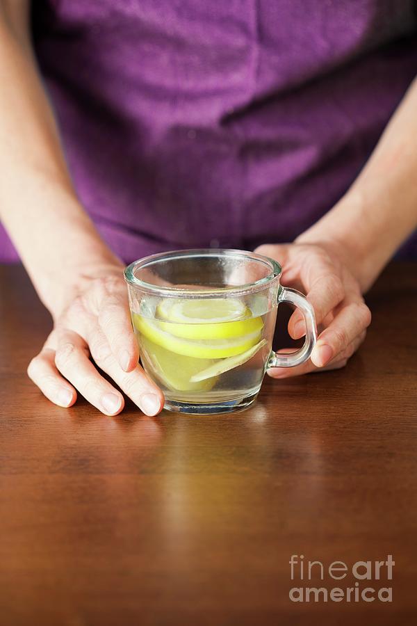 Close-up Of Hands Holding Lemon And Ginger Tea #1 Photograph by Cristina Pedrazzini/science Photo Library