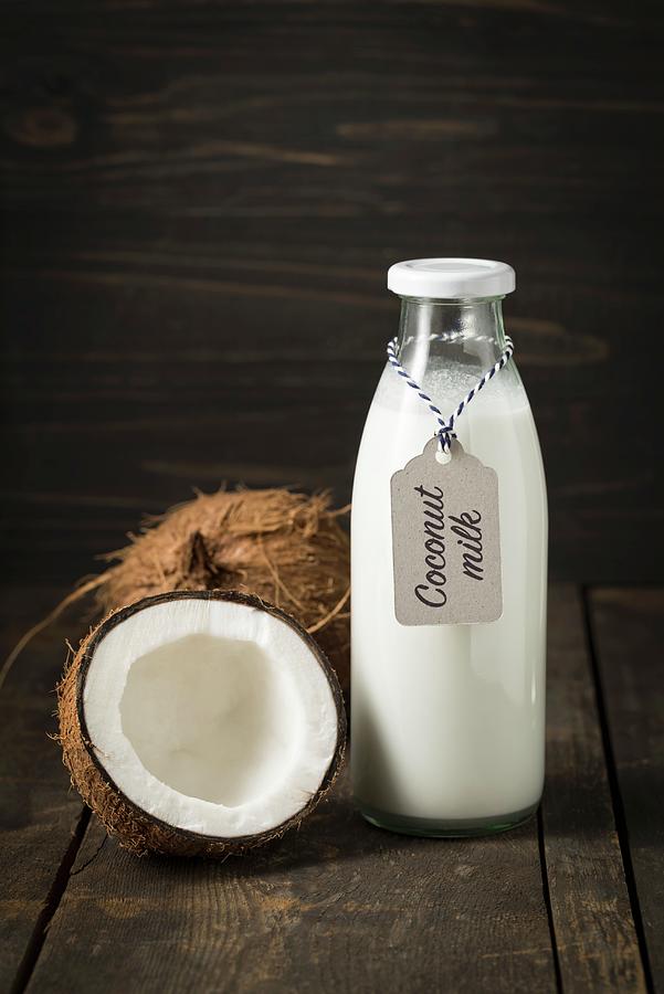 Coconut Milk In A Glass Bottle With A Label #1 Photograph by Elisabeth Clfen