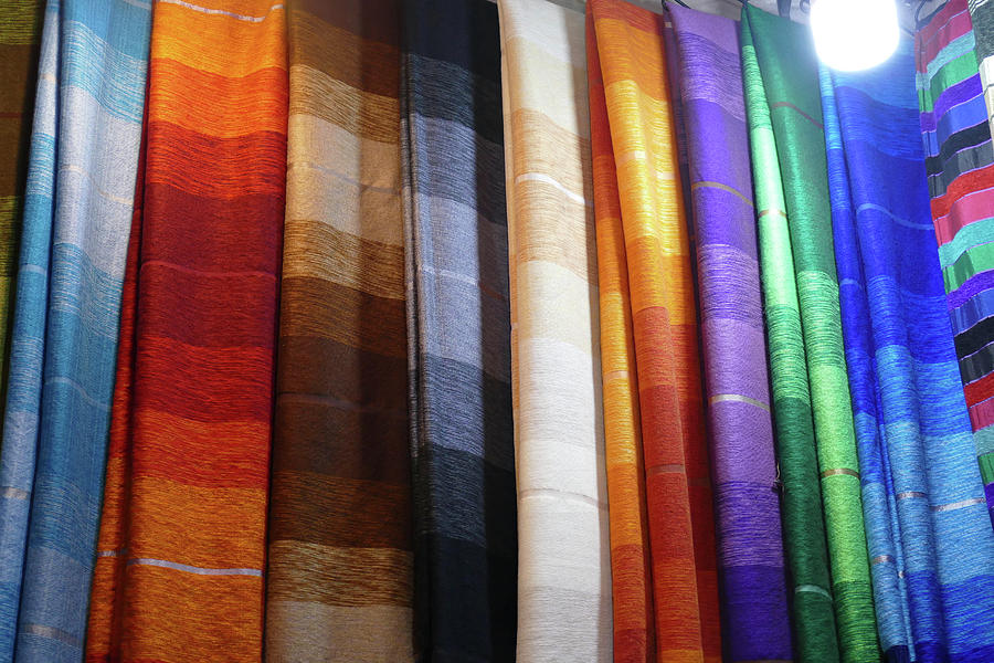 Colorful fabrics in the medina market  #1 Photograph by Steve Estvanik