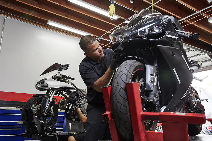 Confident Worker Working On Motorbike In Factory Photograph by Cavan ...