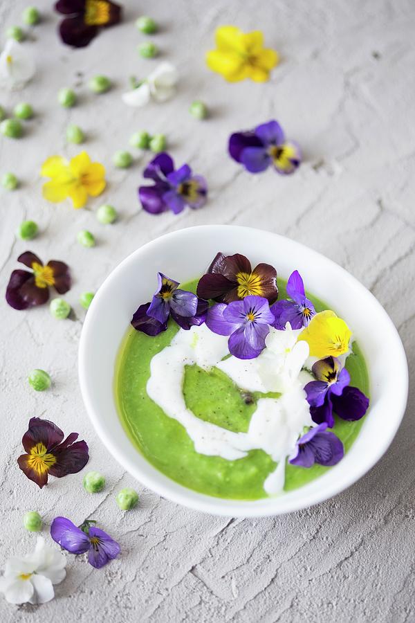 Cream Of Green Pea Soup With Sour Cream And Edible Flowers #1 Photograph by Malgorzata Laniak