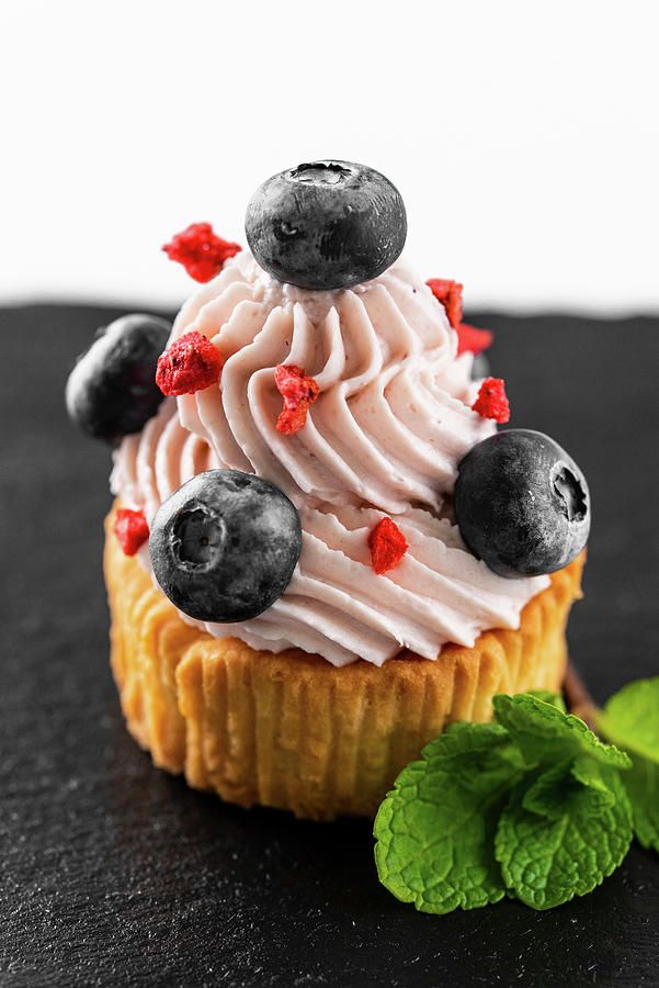 Cupcake With Buttercream And Blueberries #1 Photograph by Kuzmin5d