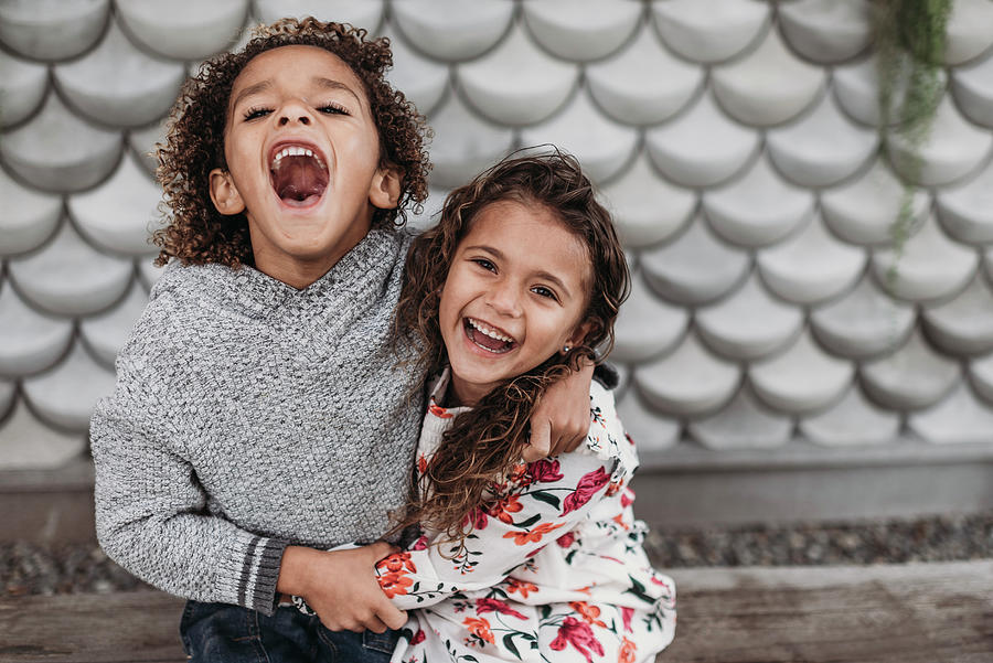 Cute Siblings Smiling And Laughing While Hugging Photograph by Cavan ...