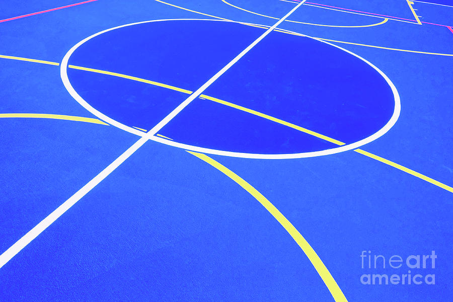 Design of a sports field, with blue background and red and yellow white lines creating strange straight lines and curves, to use with copy space. #1 Photograph by Joaquin Corbalan